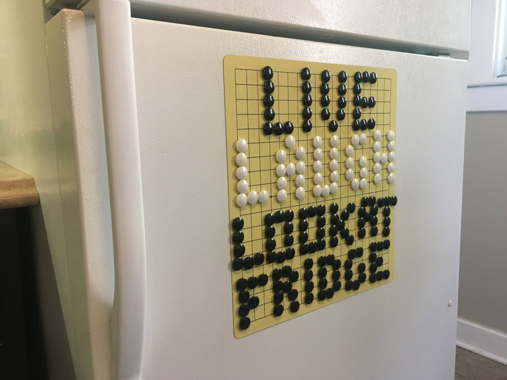 A go board on a fridge saying, 'Live. Laugh. Look at fridge'