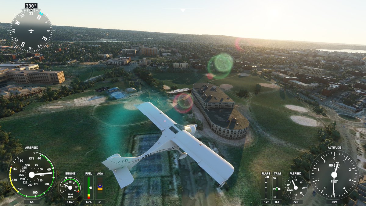 My Microsoft Flight Simulator plane flying over a brutalist oval-shaped building, which is flat pavement in real life.