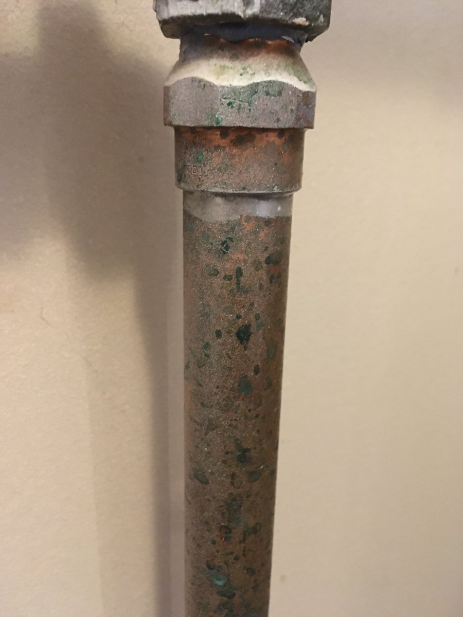 Before photo of the copper pipe, mottled and grey.