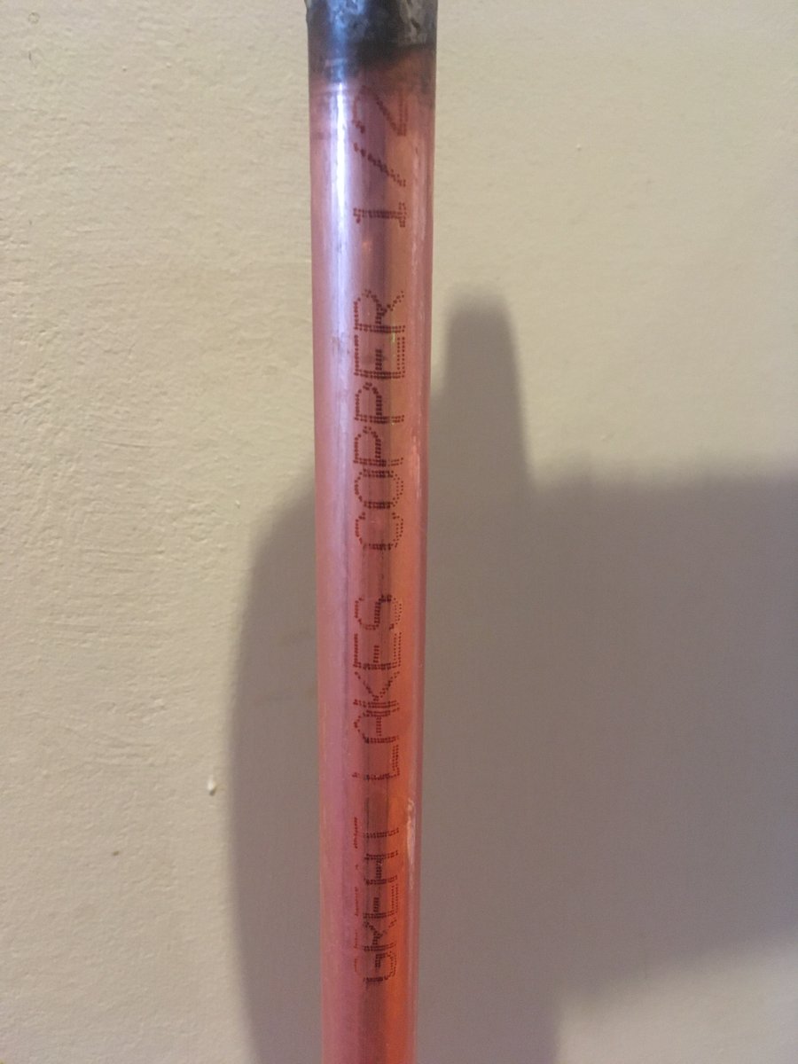A third photo of the shined copper pipe, where you can read "Great Lakes Copper 1/2" on the metal.
