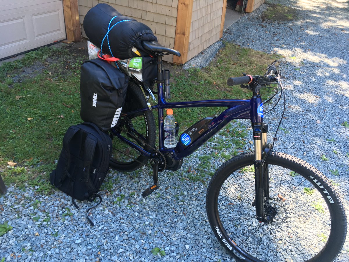 Photo of an ebike strapped with luggage.
