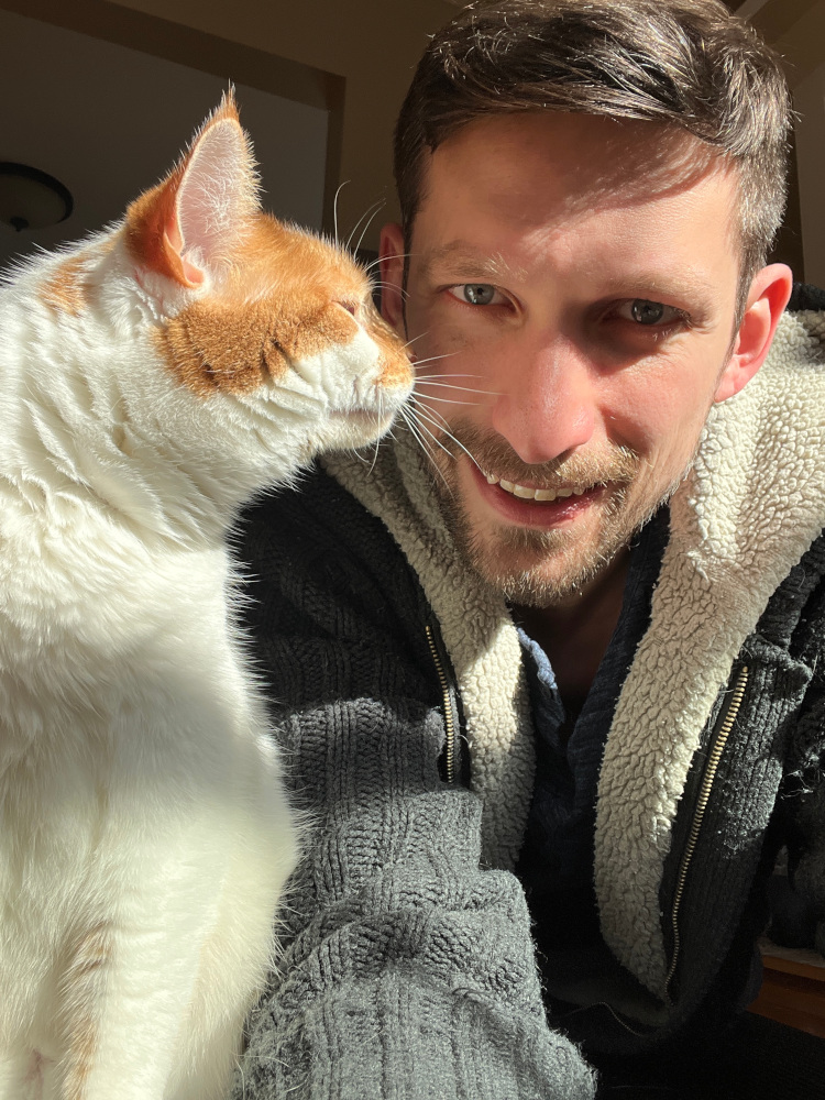 Charlie sniffs my face as I steal his good light